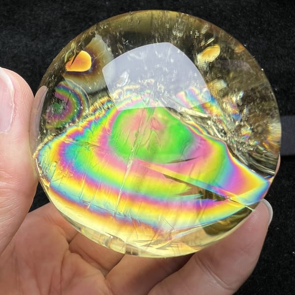 Repeat view of the citrine with layered rainbow bands and green core