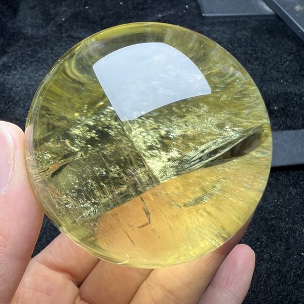Calm reverse side of the citrine sphere in pale yellow with no rainbow