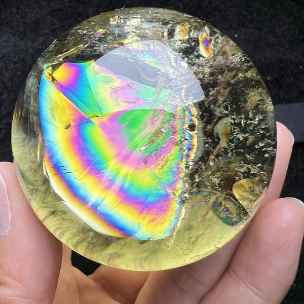 Wedge-shaped rainbow running down the left side of the citrine