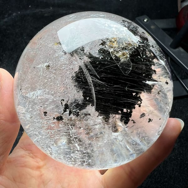 Deep green phantom cloud crossed by fine parallel rutile needles