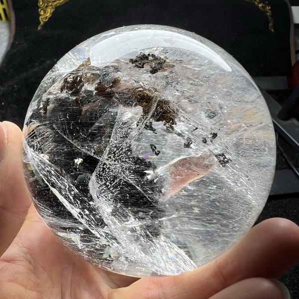Dark brown and green inclusions behind curving internal planes