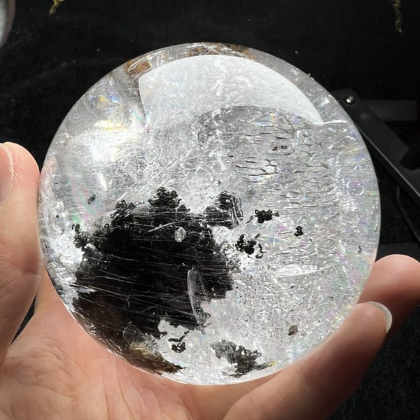 Green phantom cluster sitting low in the sphere with clear quartz above
