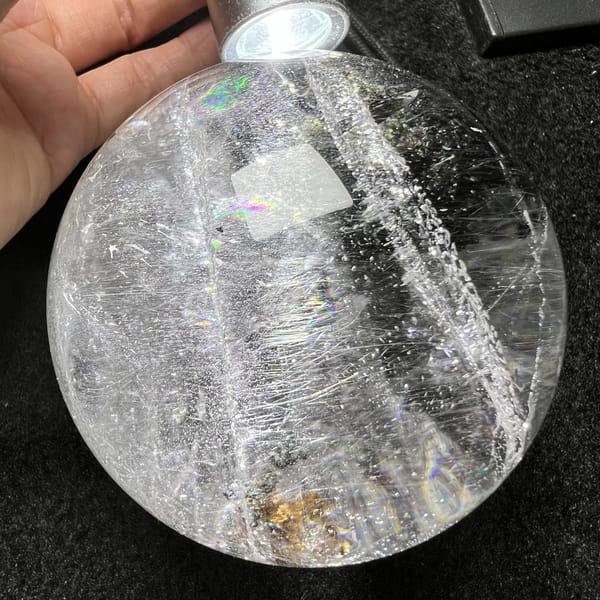 Backlit sphere showing a bright veil band and a golden patch below