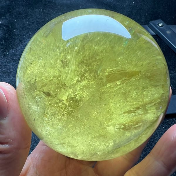 Lemon yellow citrine ball with soft upward-sweeping internal veils