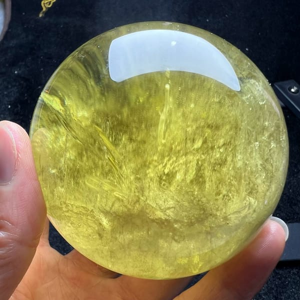 Citrine turned to show long veils and a bright upper zone