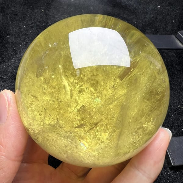 Warm golden view of the citrine sphere under direct light