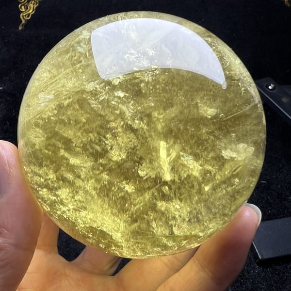 Darker honey-toned side of the citrine sphere with veils