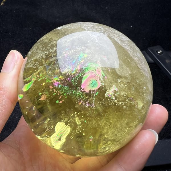 Glittering rainbow patch in the lower half of the citrine sphere