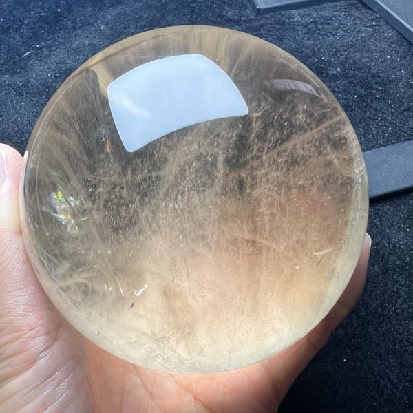 Natural pale citrine with grass-like strands and a soft rainbow glint