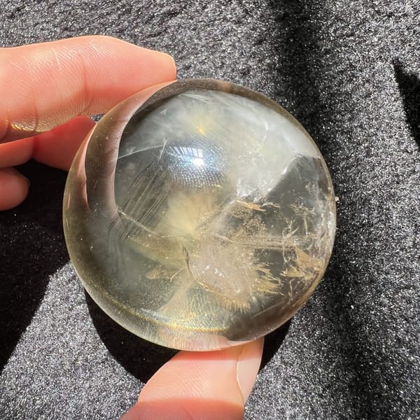 Other side of the citrine with white veils and a clear included crystal