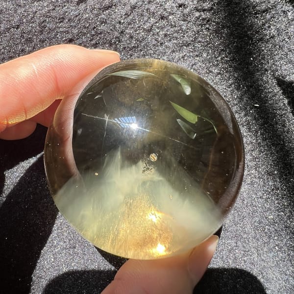 Citrine sphere angled to show glittering grains at the pyramid base