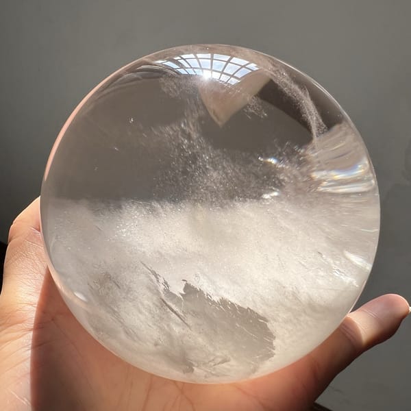 Icy feather inclusion reaching down into the white mist