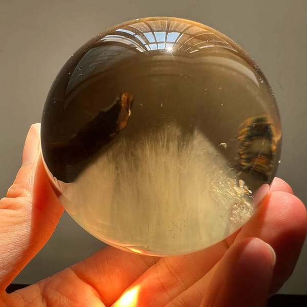 Backlit citrine showing the mountain of needles against a warm glow