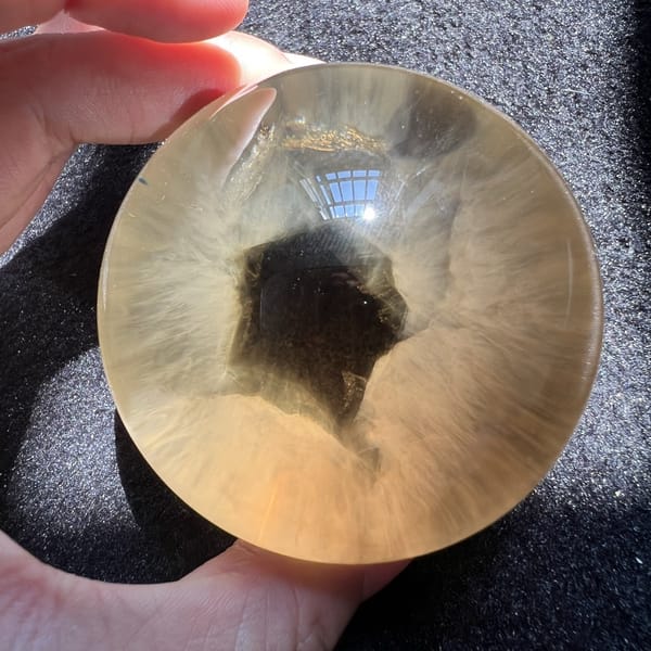 Close top view of the star-like needle burst inside the citrine