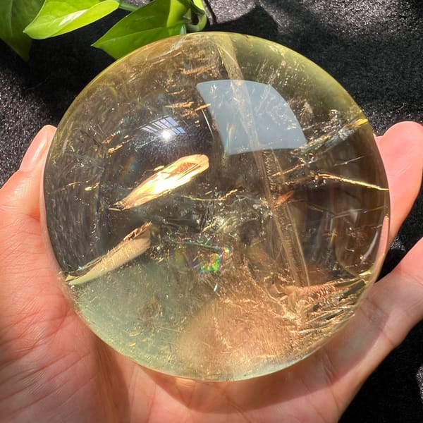 Small rainbow inside the golden veil band near the centre of the sphere