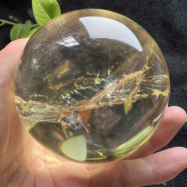 Clear pale citrine with a narrow band of glittering veils