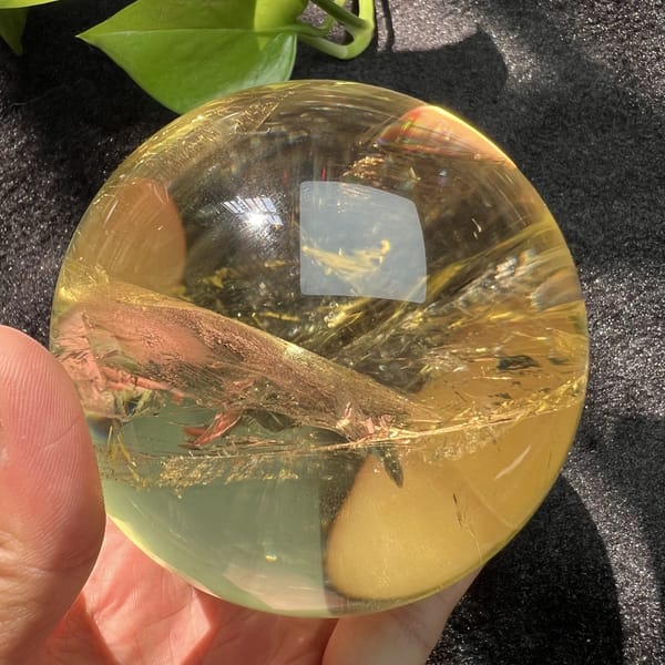 Amber-toned view of the citrine with its long golden veil