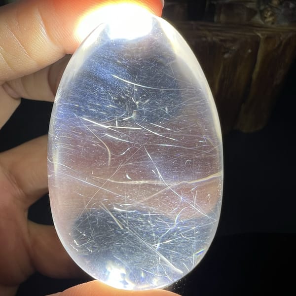 Blue haze lighting up the needles inside the backlit quartz egg