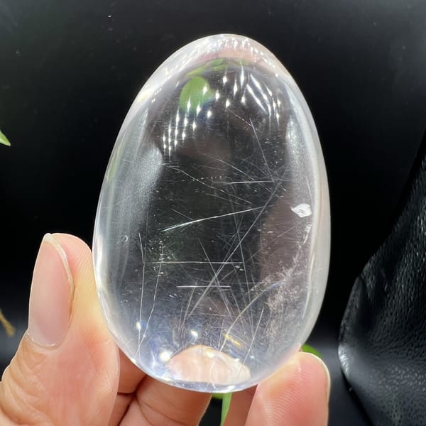 Smooth quartz egg with fine needles and a small veil near the top