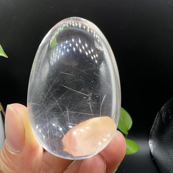 Rutile needles scattered through the lower half of the quartz egg