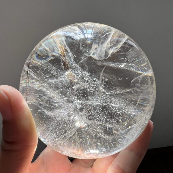 Clear sphere showing wind-blown veils and glittering points