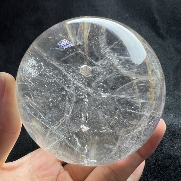 Clear sphere on black velvet with the central mica string