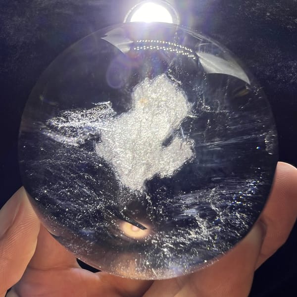 Cool blue haze filling the backlit smoky sphere around the cloud