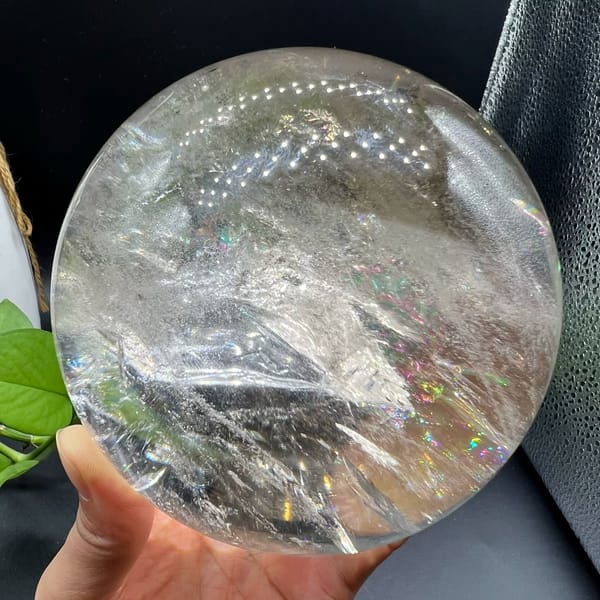 Big Brazilian quartz ball showing a ridge of veils across the middle