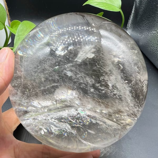 Clear sphere with a mountain-like veil ridge beside green leaves