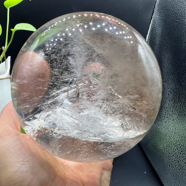 Quartz sphere with a pink reflection and white veil range below