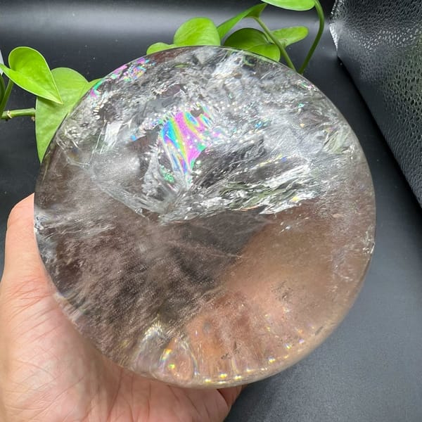 Bright pink and green rainbow at the top of the large clear sphere