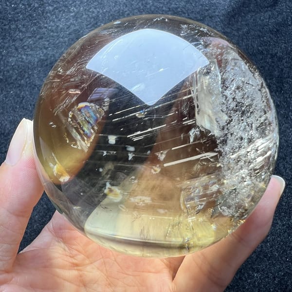 Pale yellow edge of the sphere with silver streak clusters and a rainbow fleck