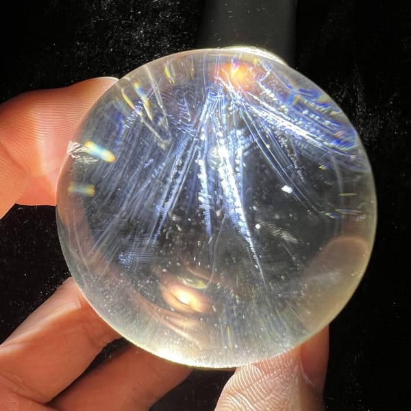 Angel feather needles splaying out like quills inside transparent quartz