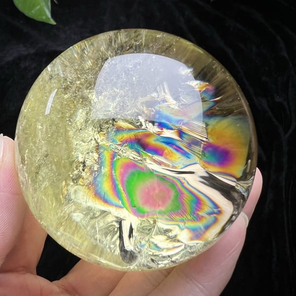 Pink-centred rainbow rings beside a white veil inside the sphere