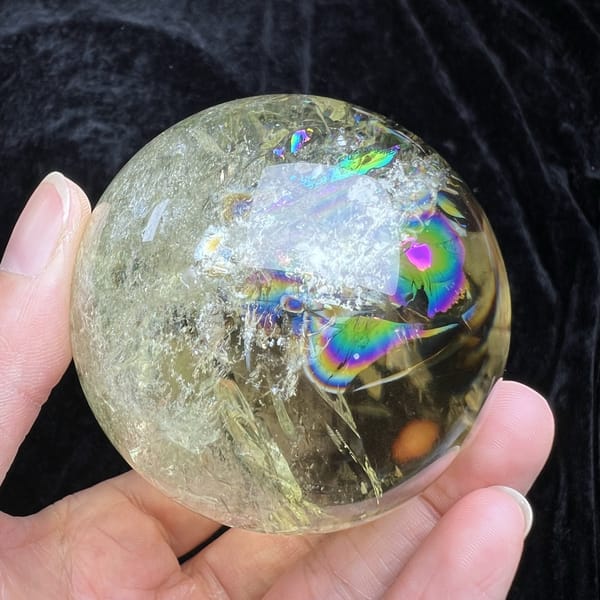 Paler face of the sphere with a small rainbow patch near the top