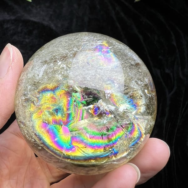 Wide rainbow band seen across the paler side of the citrine sphere