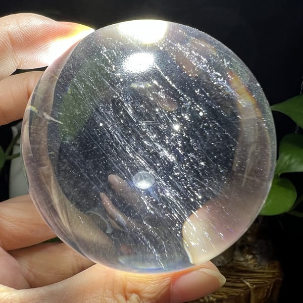 Backlit silky streaks running diagonally through the water-clear quartz