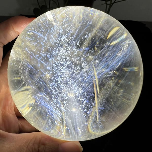 Silver mountain of white flecks framed by blue needles and golden streaks