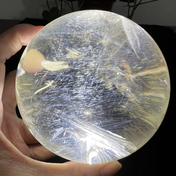 Dense field of small blue needles lit across the top half of the sphere