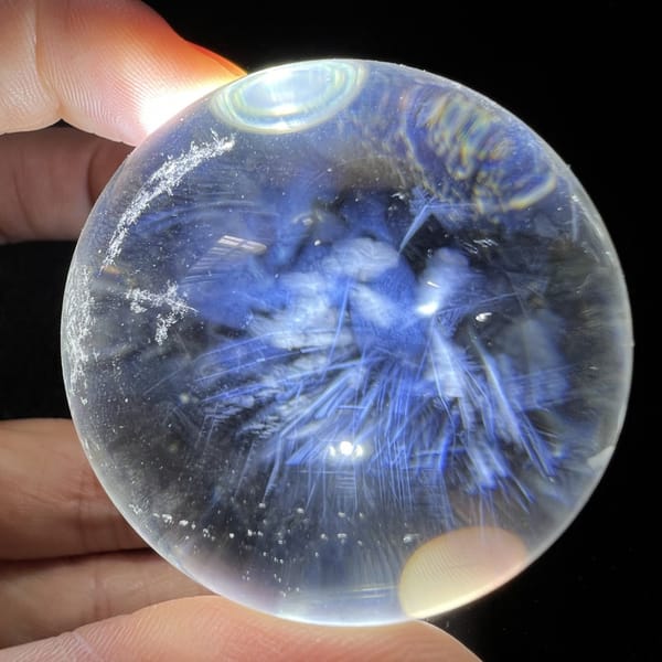 Feathery blue cluster filling the middle of the sphere from another side