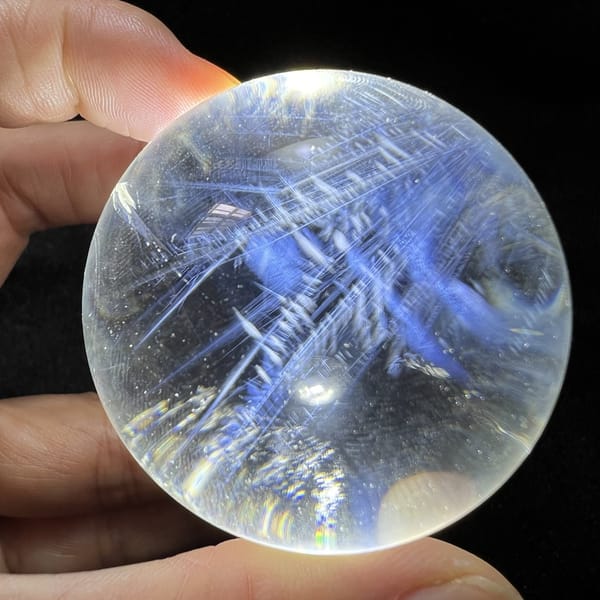 Angel feather sprays crossing diagonally through the clear quartz