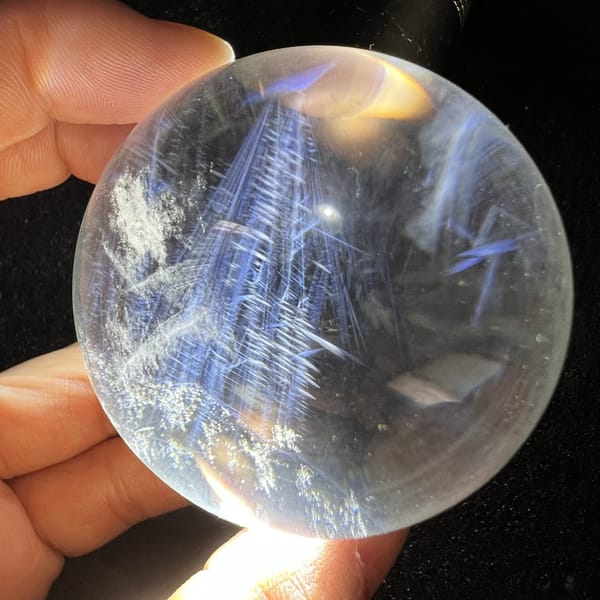White snowy cluster and blue sprays on the left side of the sphere