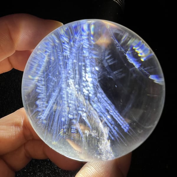 Thick bundles of blue needles reaching toward the sphere rim