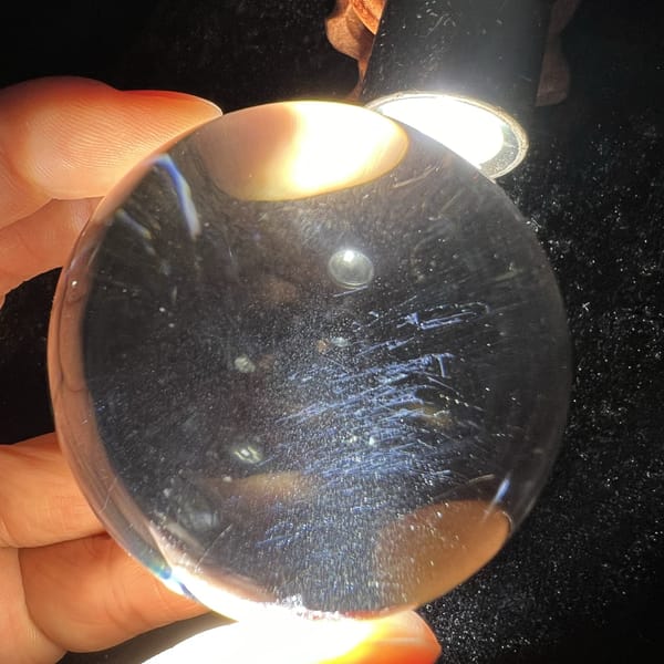 Blue needle streaks lit by a torch above the clear sphere