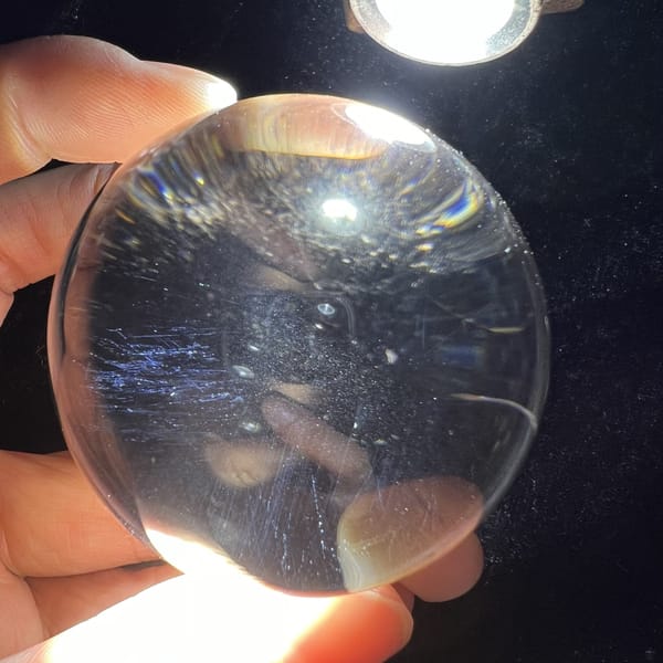 Blue needle streaks spreading across the lower half of the sphere