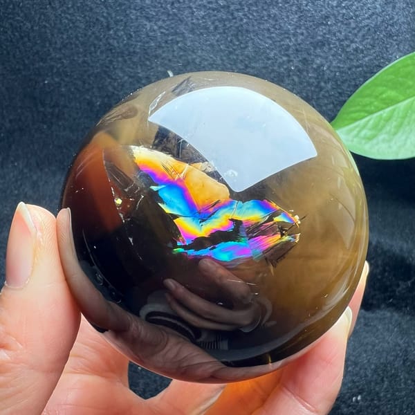 Vivid blue, violet and gold rainbow inside the smoky upper half of the sphere