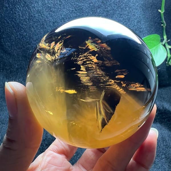 Golden reflective planes glinting through the smoky brown quartz