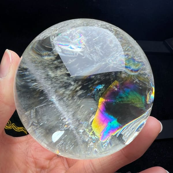 Rainbow sliver at the right edge beside a white feathery veil