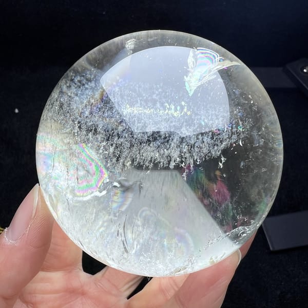 Clear side of the sphere with a white grass-like fringe and faint colour