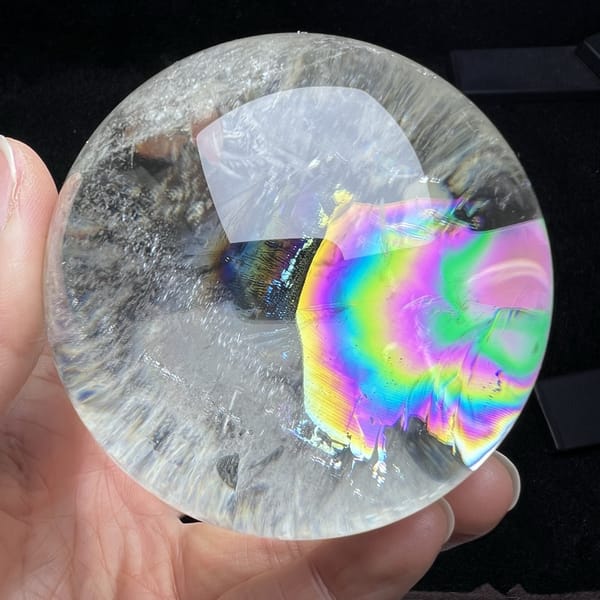 Vivid rainbow rings filling the right-hand side of the sphere